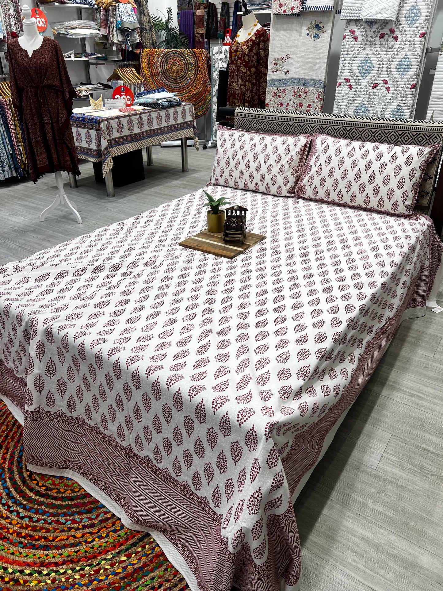 "Crimson Harmony: White Bedsheet with Elegant Red Motifs"