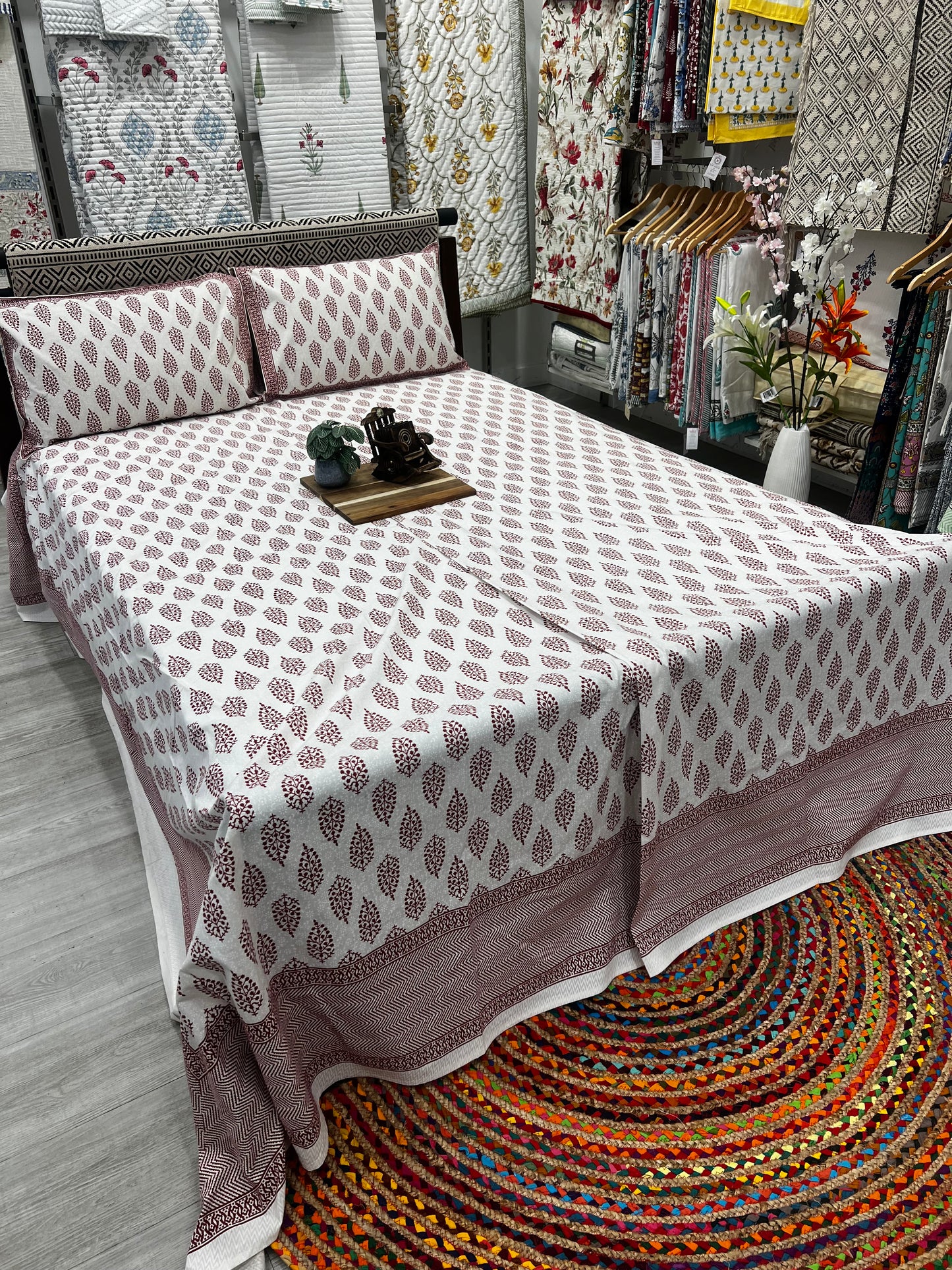 "Crimson Harmony: White Bedsheet with Elegant Red Motifs"