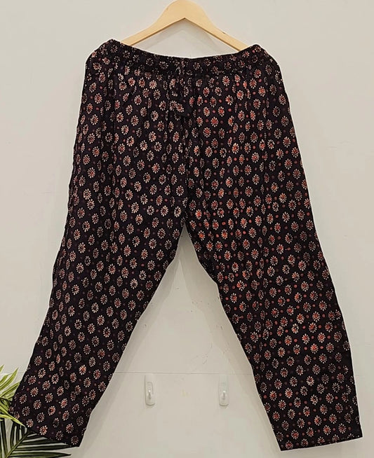 "Scarlet Accents: Stylish Black Pants with Red Motifs"